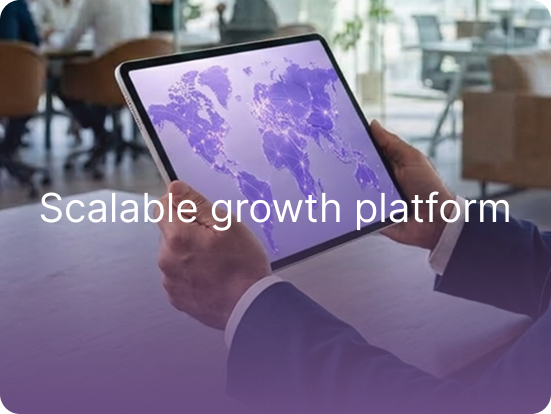 Businessman holding a tablet showing a world map in an office — scalable growth platform